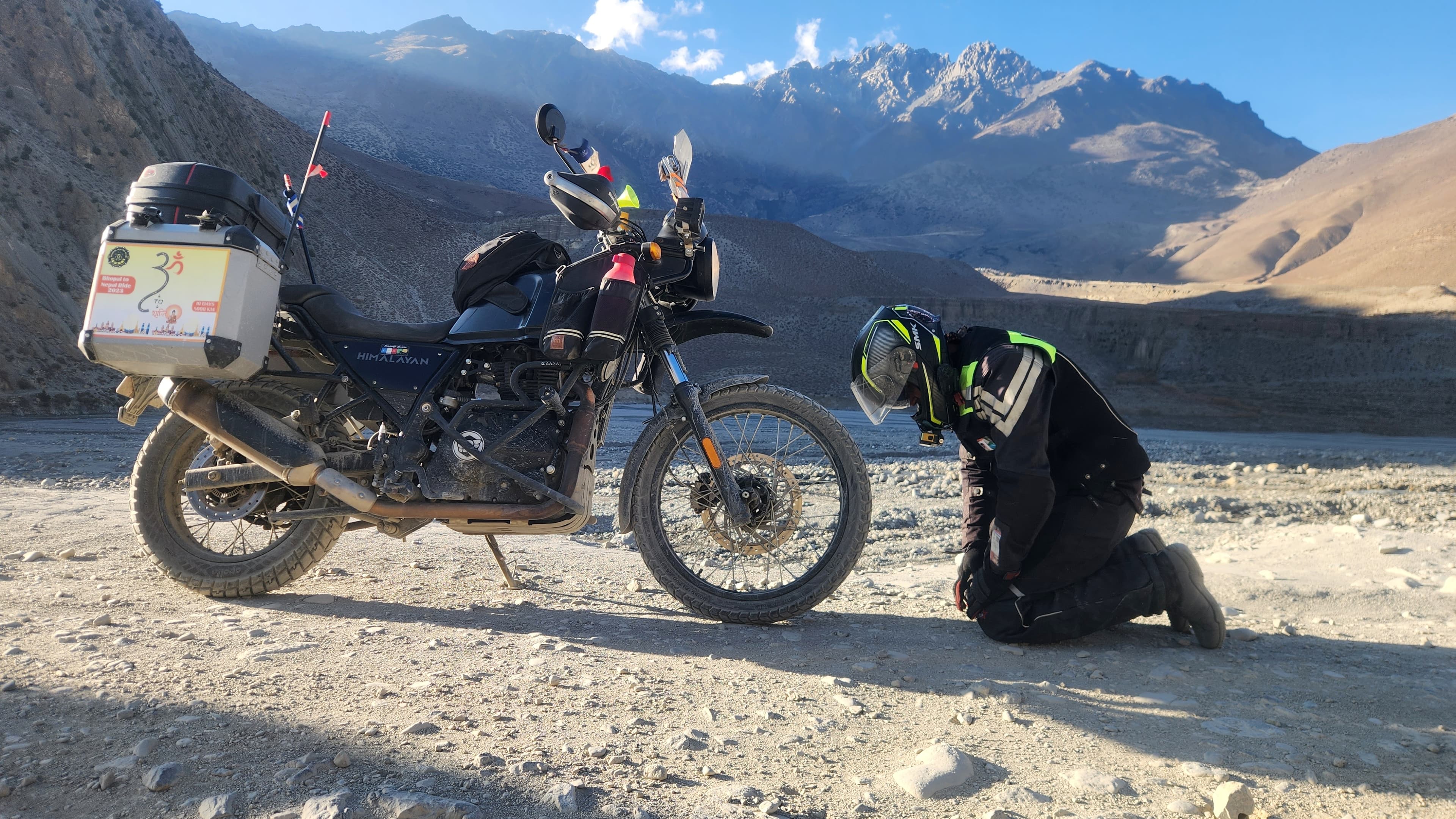 Adventure motorcycle stopped on a rugged mountain road during a BBC journey