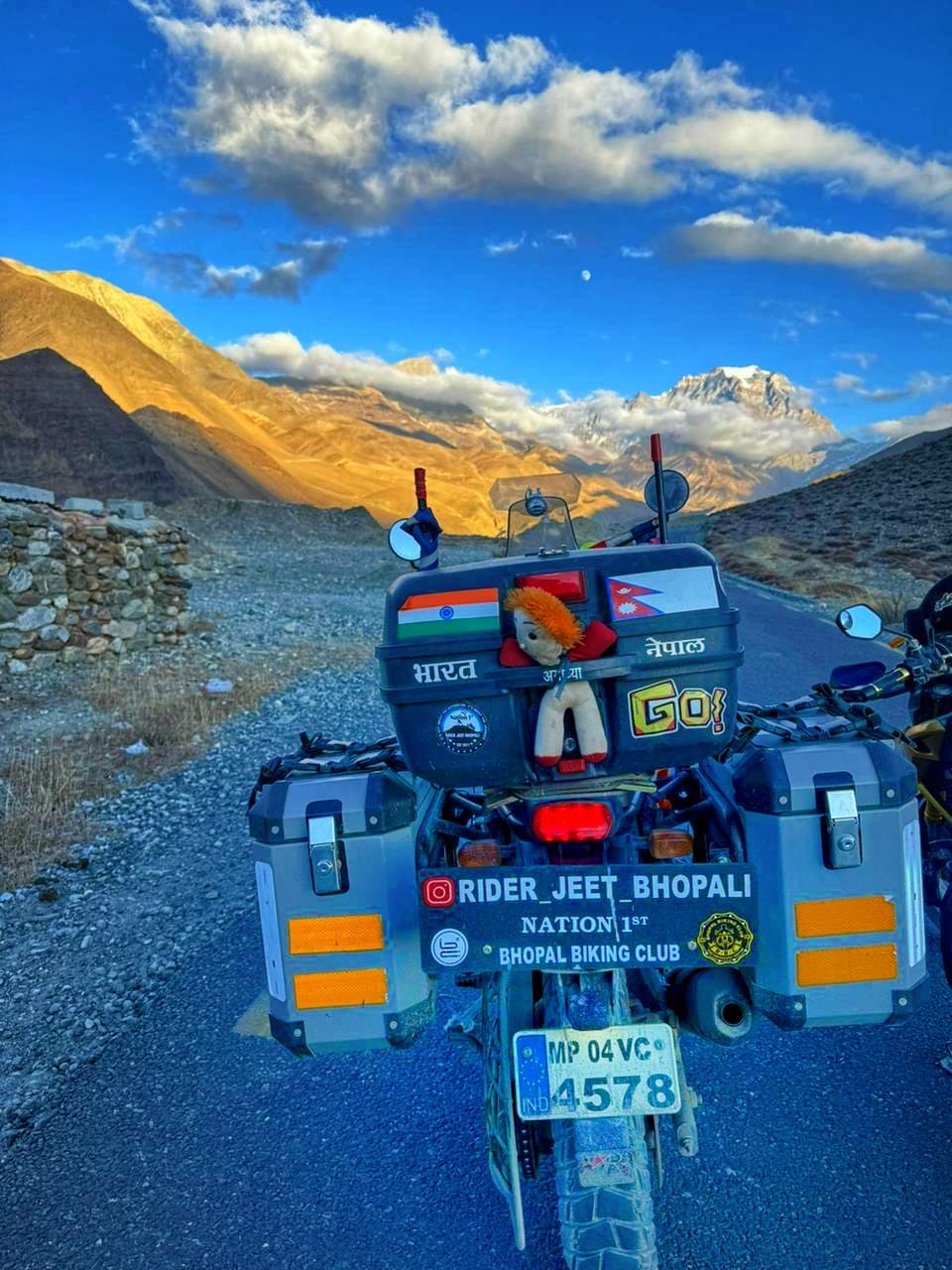 Touring motorcycle against a dramatic mountain backdrop on a BBC ride